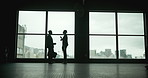 Business people, silhouette and window in airport for travel and career or international company. Conversation, journey and together for location, booking and flight or destination in city for work 