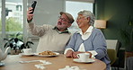 Senior couple, smile and selfie in home for memory at breakfast table with cookies, food and coffee. Happy man, woman and picture together in retirement for funny conversation, laughing or bonding