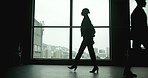 Walking, office and silhouette of woman in window, thinking and agenda in law firm. Female lawyer, colleagues and lobby in building for scheduled meeting, professional and business in workplace