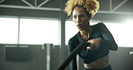 Woman, battle rope and workout in gym, cardio exercise and muscle building for fitness. Intense routine, moving and body wellness with power or strength training, weight equipment and bicep challenge