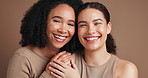 Friends, face and cosmetics in studio for skincare, makeup and embrace on brown background. Women, portrait and confident in dermatology or foundation glow, facial treatment and support for beauty