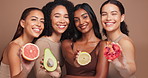 Women, face and fruit in studio for skincare with diversity, organic cosmetics and natural makeup or beauty. Inclusion, vitamin c and happy with citrus for detox or hyperpigmentation and equality.