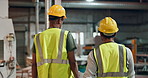 Architecture, men and walking in factory, back and safety with schedule, civil engineering and teamwork. Helmet, people or coworkers with vest, industrial or maintenance with collaboration or storage