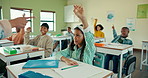 School, kids and classroom with students with questions for growth, development and attention to education. Study, learning and children with hands up for knowledge, exam notes and stationery at desk