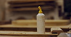 Carpentry, glue and production with bottle in workshop for joinery, manual labor or woodwork. Construction, industry and manufacturing with adhesive product in empty factory for professional service