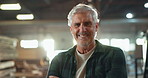 Carpenter, face and mature man in workshop with smile for manufacturing, production or confidence. Business, portrait and male supervisor for crafting, woodwork or furniture industry in warehouse
