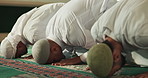 Bow, people and group prayer in Mosque for peace, Palestine and gratitude to Allah in holy temple. Support, spiritual belief and Muslim men worship God on carpet or Ramadan Kareem in Saudi Arabia