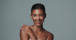 Face, makeup and skincare of happy Indian woman in studio isolated on gray background. Portrait, touch and beauty of young model for facial cosmetics, dermatology or laughing for healthy glow at spa