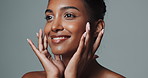 Face, skincare and beauty of happy Indian woman in studio isolated on gray background. Touch, smile and young model in makeup for facial cosmetics, dermatology or healthy glow for aesthetic at spa