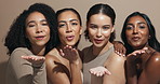 Face, women or blowing kiss for skincare, glow or wellness with smile, inclusion or makeup cosmetics in studio. Flirting, hug or happy people with group, beauty results or support on brown background