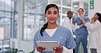 Indian woman, face and nurse on tablet for research in clinic, app and planning for treatment. Female person, online consulting and networking contact for hospital, healthcare and support in portrait