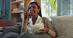 Laugh, sofa and woman with popcorn for watching tv, comedy show or streaming subscription service in home. Relax, snacks and happy girl on couch for funny movies, television or weekend in living room