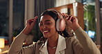 Happy woman, headphones and night with music for podcast, radio or dancing to sound at home. Young female person or freelancer with smile for late audio track, playlist or album on laptop at house