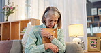 Senior, woman and sad with photograph on sofa for reminiscing, nostalgia and remember memory of history or past. Elderly person, hug and thinking on couch with picture, missing and mourning in home.