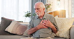 Senior man, house and cough with chest pain on sofa in living room with asthma attack. Pensioner, heartburn or heart ache on couch with lung infection, bacteria and chronic medical condition and sick