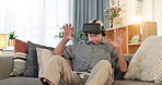 Senior, happy man and playing with VR on sofa for virtual entertainment, reaction or interaction at home. Elderly or surprised male person in shock for future gaming or user experience in metaverse