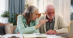 Senior couple, documents and finance with laptop for discussion, budget planning or calculation at home. Elderly man and woman discussing financial paperwork, expenses or bills on computer at house