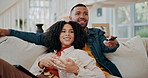 Black couple, popcorn and streaming movies in home, subscription and film snack for television. People, relax and remote for choosing entertainment in lounge, hug and couch together for marriage