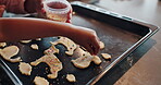 Cookies, hands and baking with child for dessert, food and family in kitchen with recipe. Snack, decorations or childhood development for young person, sprinkles or cooking with ingredient with dough