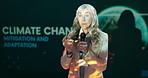 Presentation, conference and mature woman with mic for climate change workshop for sustainable company. Seminar, eco friendly and female speaker on podium at convention for earth development at event