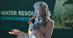 Presentation, speaker and business woman with mic for water management workshop with resources. Seminar, talking and female presenter on podium at convention for agro sustainability research at event