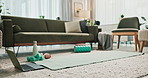 Empty, house and exercise with equipment on floor for pilates, online class and interior of space. Sofa, water bottle and dumbbell with technology on ground for streaming, virtual workout and lesson