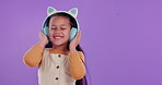 Happy girl, child and listening with headphones in studio for music, audio or streaming on a purple background. Young female person or little kid with smile for sound, playlist or album on mockup