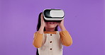 Girl, child and virtual reality with glasses in studio for 3d video of movie, film or app by purple background. Kid, ar goggles and game in futuristic digital world in metaverse for user experience