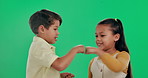 Happy children, friends and fist bump with green screen in studio for greeting or friendship on background. Portrait of young girl and boy touching hands with smile for agreement, deal or partnership