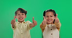 Happy children, friends and agreement with thumbs up on green screen, studio or background. Portrait, young or little boy and girl with smile, like emoji or yes sign for winning, review or feedback