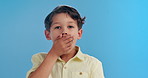 Shock, surprise and face of child on blue background for news, announcement and information. Youth, childhood and portrait of young boy with facial expression, emoji reaction and wow in studio