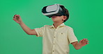 Little boy, vr and future with green screen for interaction, 3D experience or virtual world on studio background. Young child or kid looking around in metaverse for futuristic game or entertainment