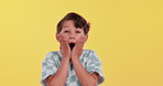 Excited, surprise and face of child in studio for news, announcement and information. Wow, emoji and portrait of young boy with shock for candy store sale, deal and discount on yellow background