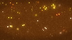 Light, bokeh and sparkle in space with glitter, shine and reflection with abstract texture, creative or movement. Glowing shapes, closeup or celebration on brown background for spotlight or particles