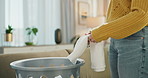 Woman, hands and basket to fold clothes in home, laundry and clean linen or domestic chores. Female person, cotton and housework tasks or tidy material or textiles, fabric and maid packing or care