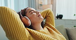 Woman, headphones and calm music to relax in home, streaming online and peaceful podcast on sofa. Female person, audio and hearing sound on couch for getting ready to nap, listening and comfortable