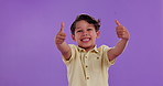 Happy boy, child and thumbs up with emoji in studio for feedback, review or good news on a purple background. Portrait of male person or little kid with smile, like or yes sign for approval or agree