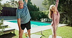 ​​Mature couple, stretching and home fitness with wellness, balance and workout in backyard. People with pilates, yoga and exercise together for muscle health for holiday, break or pension activity