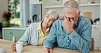 Comfort, kitchen and sad senior couple with grief, loss and emotions together with care at home. Support, love and worried mature woman hugging husband for crying with bankruptcy or financial crisis.