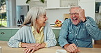 Laughing, conversation and senior couple in kitchen by table on weekend morning for coffee together. Happy, love and mature man and woman bonding, talking and drinking cappuccino at home in Australia