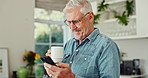 Cellphone, coffee and mature man in kitchen with pride for stock investment profit with online bank app. Happy, phone and senior male person drink cappuccino and reading news blog on internet at home