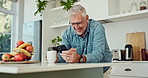 Phone, coffee and man in kitchen laughing at funny, comic or comedy joke online on blog. Happy, cellphone and mature male person with cappuccino reading silly email communication on internet at home.