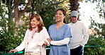 People, nurse and walking with senior couple for help, support and happy with care in garden. Nursing home, smile and pensioner with caregiver in healthcare, rehabilitation and exercise with fun