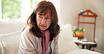 Sad, senior woman and thinking in nursing home with memory, grief and mental health. Alzheimer, stress and living room with mourning widow on a sofa in retirement with depressed grandmother 