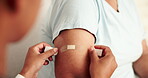 Clinic, patient and arm of woman with bandage in injection for healthcare, protection and parasite safety. Medical, help and hands of person with band aid for malaria vaccine, immunization or support