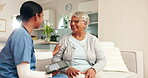 Smile, tablet and nurse talking to old woman on sofa in living room of apartment for insurance or medical results. Conversation, healthcare or wellness with caregiver and senior in retirement home