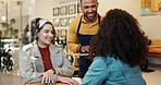 Friends, waiter and women order at cafe on tablet for decision, choice or help with menu. Smile, customer service and girls with server at coffee shop to talk, listen or relax together in restaurant