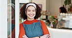 Arms crossed, friendly and smile with coffee shop waitress in doorway for hospitality or welcome. Cafe, confident and portrait of happy barista woman in restaurant for small business or startup