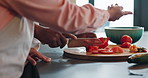 Cooking, food and hands of couple with vegetables in house kitchen for cutting, meal prep and nutrition. Healthy diet ingredients, tomatoes and people with knife for vegan dinner, lunch and salad