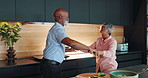 Dancing, happy and senior couple in kitchen with romance to music, radio or song at home. Love, bonding and elderly man and woman embracing for groove and cooking dinner meal at apartment together.